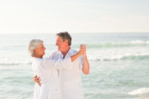 Happy Elderly Couple Dancing on the Beach